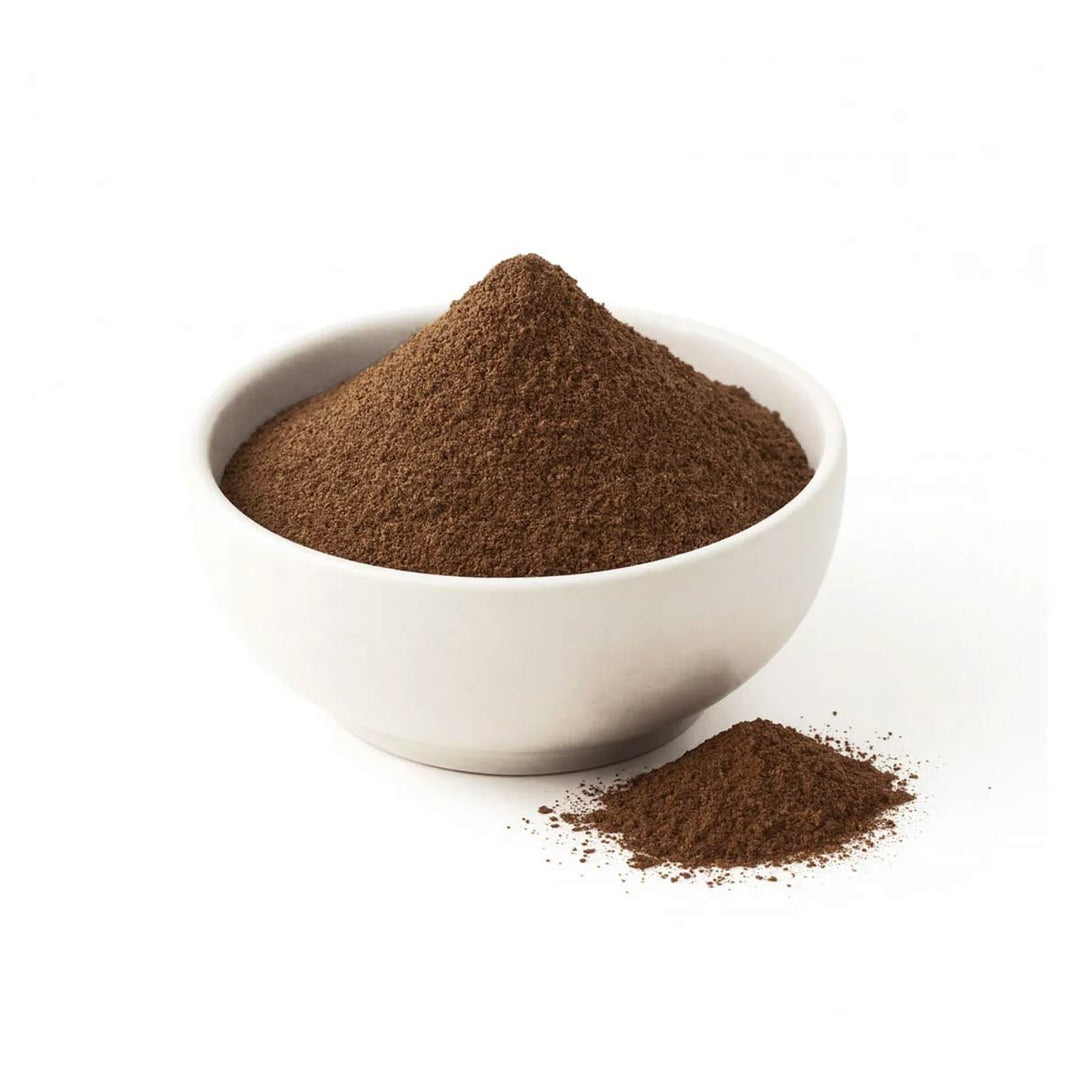 Roasted Golden Blend wattleseed powder in a white ceramic bowl with a small sprinkle beside it
